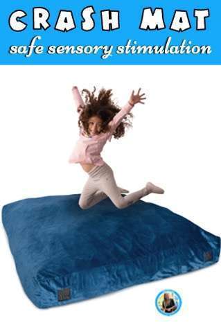 Girl jumping on large blue crash mat.
