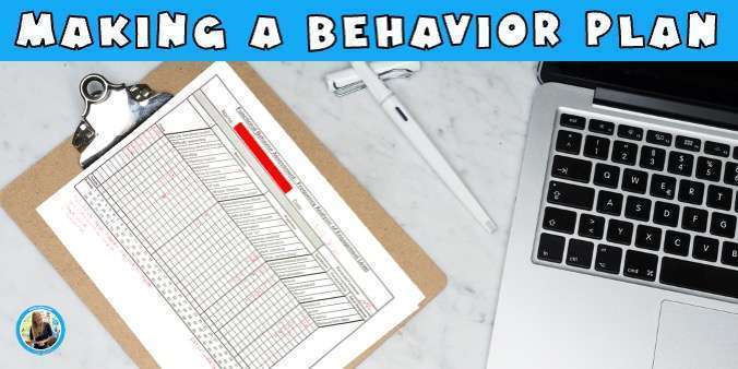 A behavior plan frequency chart on a clipboard next to a laptop.