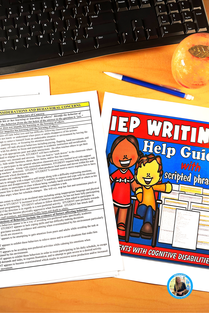 IEP writing help guide with scripted phrases to teach special ed on a teacher's computer desk.