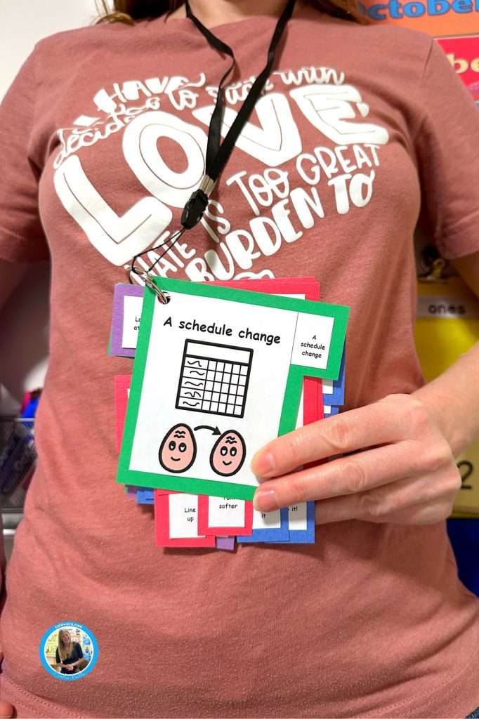 Free cue cards showing a schedule change card on a teacher's lanyard at school